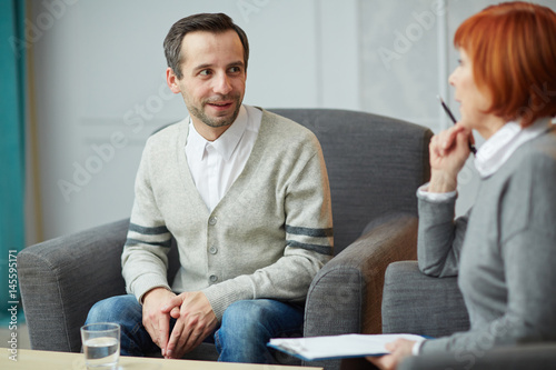 Young man discussing his problems with psychiatrist