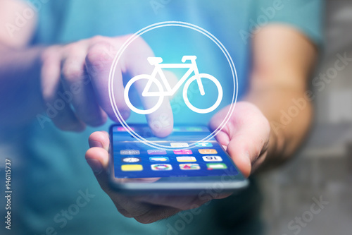 Bicycle icon over device - Sport and technology concept