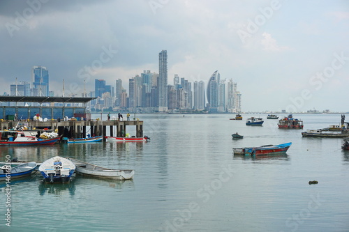 Panama city fishing harbor wharf and boats with skyscrapers buildings in background, Pacific coast of Panama, Central America