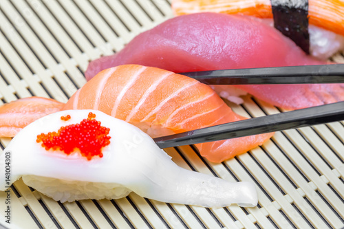 Sushi with black chopsticks