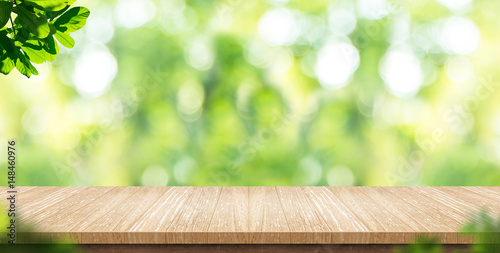 Empty wood plank table top with blur park green nature background bokeh light,Mock up for display or montage of product,Banner or header for advertise on social media,Spring and Summer concept © weedezign