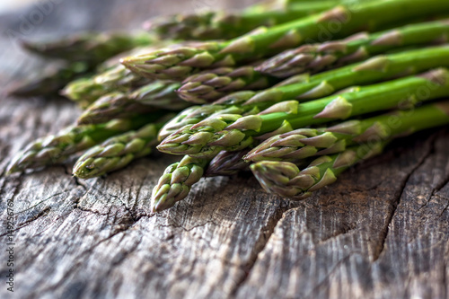 Fresh organic asparagus on rustic background