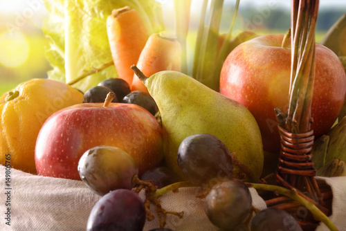 Fruits and vegetables in wicker basket front view close up