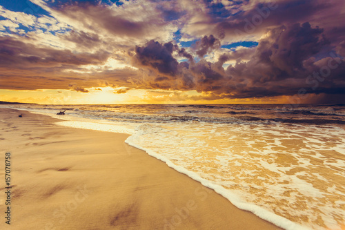 Fototapeta Beatiful sunset with clouds over sea and beach