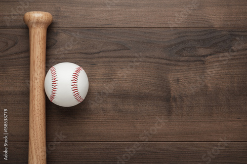closeup of baseball bat and ball on wooden table with copy space © Ruslan Grumble