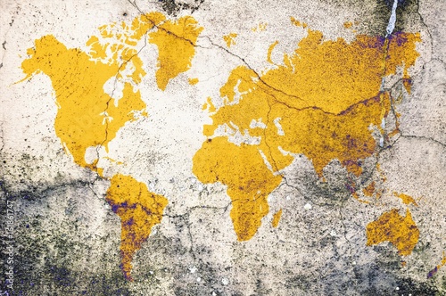 Obraz Fotograficzny Yellow world map on damaged cracked concrete wall. Elements of this image furnished by NASA.