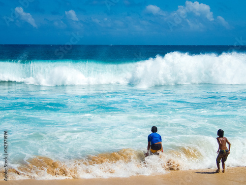 10 Year Old Boys Play In Surf Shipwreck Beach Near Grand Hyatt 10 Year Old Boys Play In Surf Shipwreck Beach Near Grand Hyatt Koloa