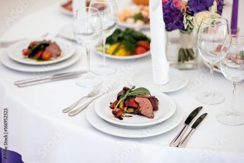 Banquet in restaurant. Table setting, fresh food. © dmitry_dmg
