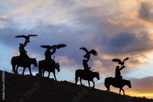 Silhouette of Mongolian Eagle Hunters near Ulgii, Mongolia Poster