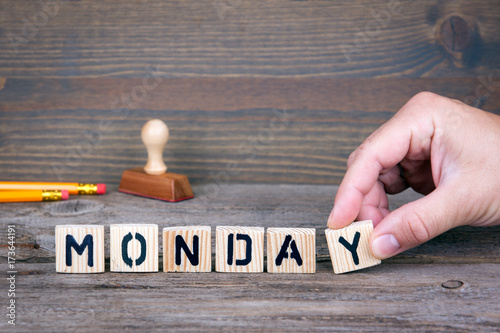 Monday. Wooden letters on the office desk, informative and communication background.