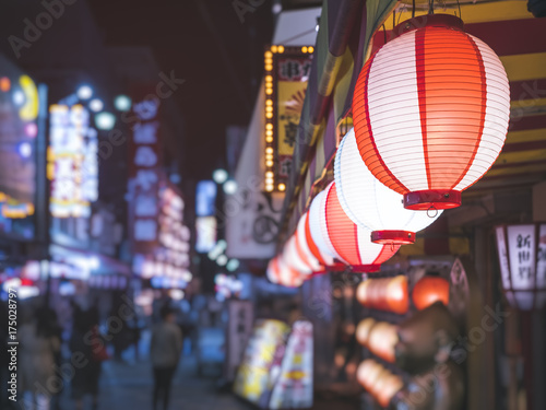 Lanterns light Japan nightlife Bar street district with blur people