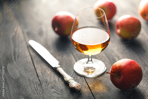 Glass of brandy on black background
