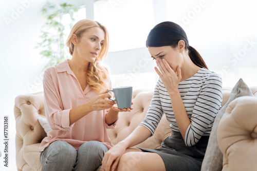 Nice sympathetic woman holding a cup of tea