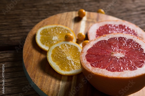 Cape gooseberry with sliced grape fruit and sweet lemon on table