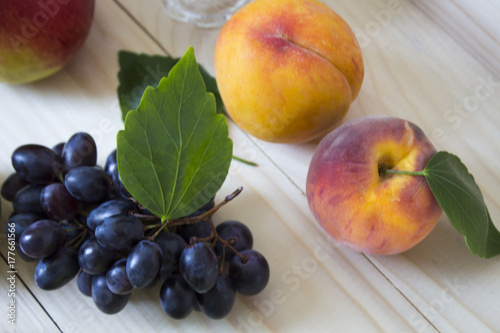 Fruit of the fall of autumn. apples, pears, blue grapes, peaches and juicе.background. fruit with green leaf