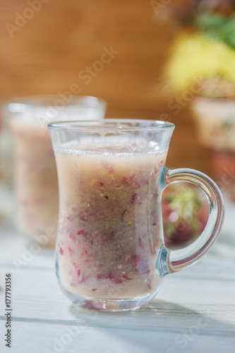 Grape smoothie over the white table.