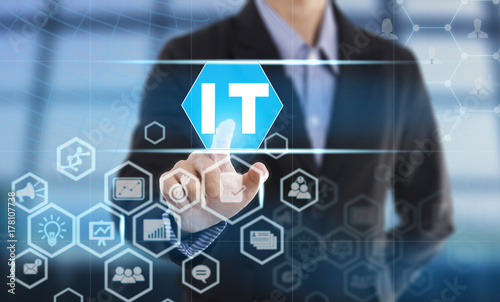 Businessman hand chooses IT wording on interface screen. internet technology service concept. can used for cover page presentation and web banner.