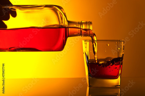 Bottle and glass of whiskey.