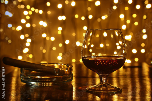 Whiskey, cognac, brandy and cigar on wooden table.