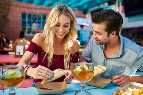 romantic couple eating street tacos at outdoor mexican restaurant © Joshua Resnick