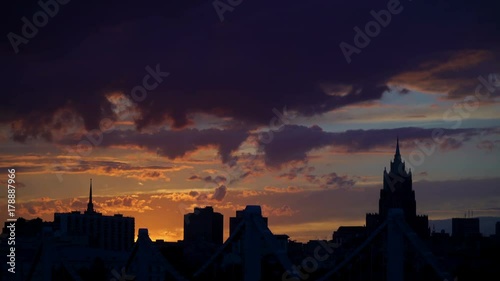 Beautiful sunset to night transition over city downtown skyline. Night city skyline sunset. Silhouette with Flare. Timelapse. Bird flying at sunset