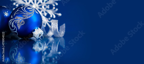 Blue christmas ornaments on blue background. Merry christmas greeting card, banner. Winter holiday xmas theme. Happy New Year. © elenabdesign