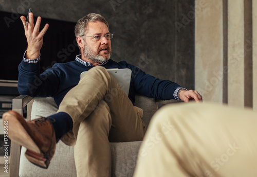 Psychologist talking with patient during the therapy