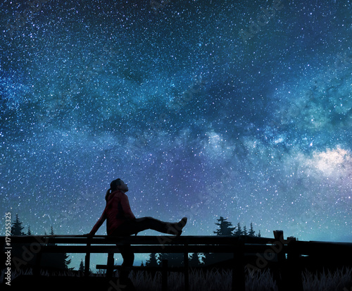 Girl watching the stars in night sky