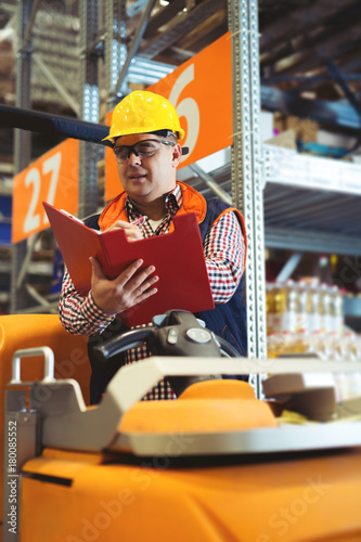 Manager In Warehouse With Clipboard