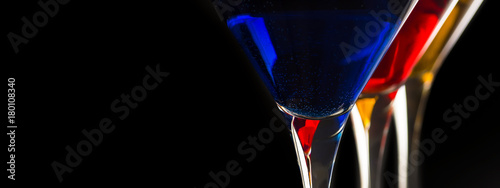  Colorful Cocktails in Martini Glasses on Black Background. Bar Commercials Concept.