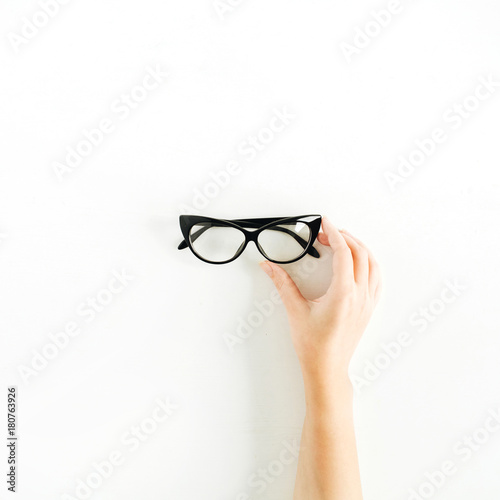 Glasses in woman hand. Minimal flat lay, top view.