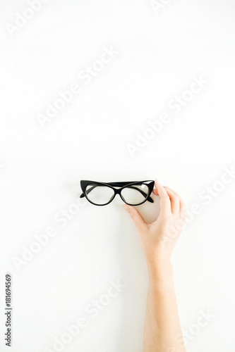 Glasses in woman hand. Minimal flat lay, top view.