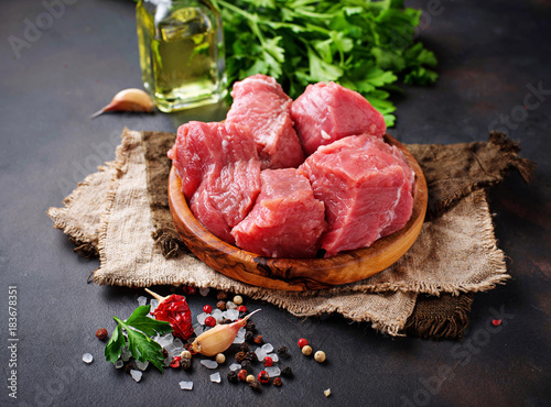 Obraz Fotograficzny Raw chopped meat with spices on rusty background