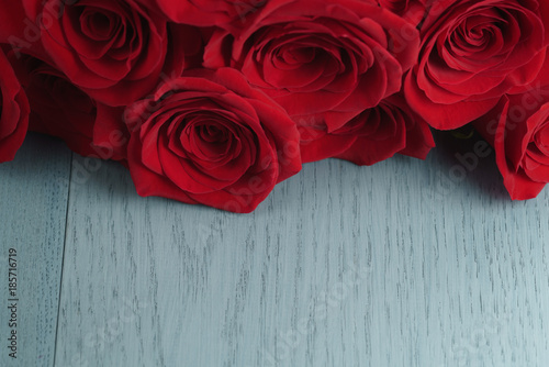 red-roses-on-light-blue-wood-background