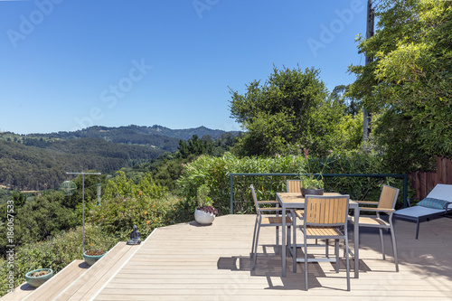 Amazing Patio Wooden Deck With Outdoor Furniture And Mountain View Amazing Patio Wooden Deck With Outdoor Furniture And Mountain View At Daytime