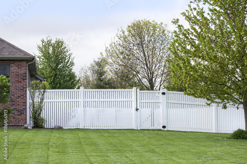 Contemporary White vinyl fence enclosing a backyard © G