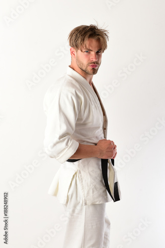Karate man in kimono posing in studio. © Roman Stetsyk