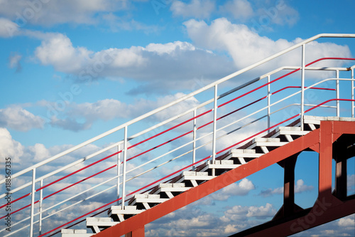 Obraz na płótnie stairs up on the background of blue sky with clouds