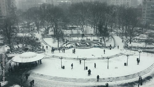 Obraz na płótnie Figures moving through Union Square during a snow storm in New York City