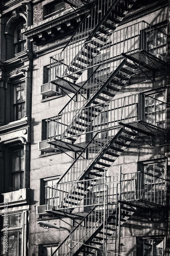 Obraz na płótnie Outside metal fire escape stairs, New York City, black and white
