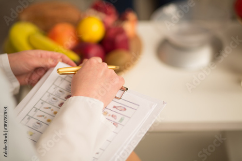 Close up image of note book and pen of dietitian. Healthy life style concept.