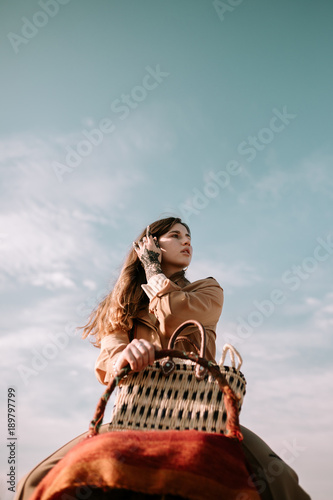 Young woman riding on camel © Juanje Garrido