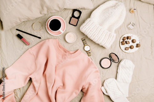 Female fashion look with stylish clothes and accessories. Lifestyle flat lay, top view composition with sweatshirt, cosmetics and coffee.