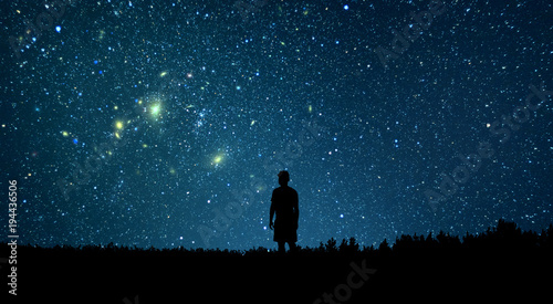 Man looking at the stars. Alone man looking at starry sky. Night sky.