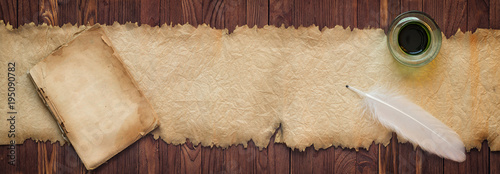 Quill with ink near the old scroll, background for text in high resolution