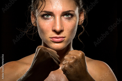 Female empowering inspiring motivational portrait of female fighter in self defense stance