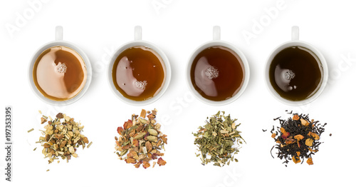variety of tea blends with relative cups on white background