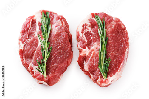 Fresh raw pork steaks and rosemary isolated on white background. © vitals