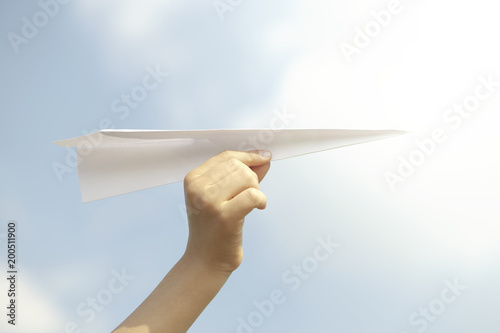 dream concept of a person flying a paper plane in the sky © Cristina Conti