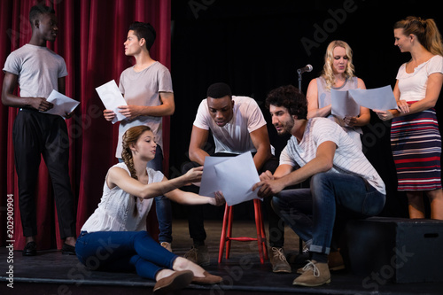 Actors reading their scripts on stage © WavebreakmediaMicro